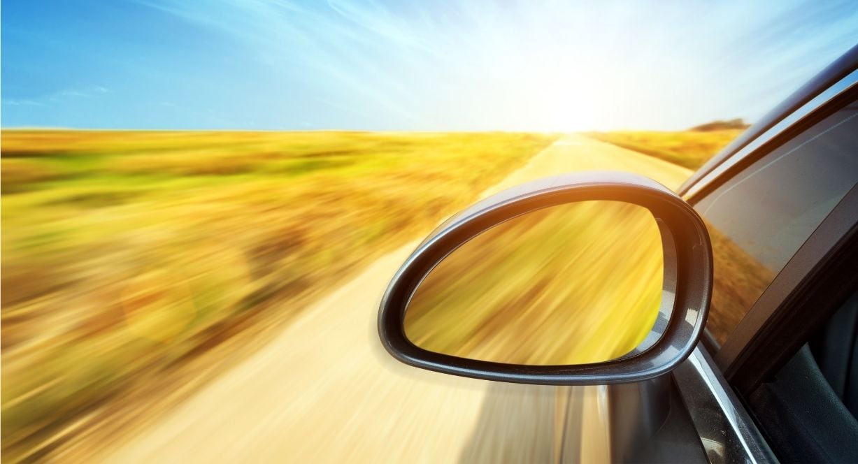 Car driving quickly down highway - evolve financial reporting