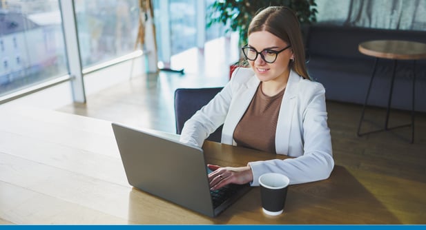 Businesswoman in a modern office contemplates migrating from Microsoft Dynamics Great Plains to Sage Intacct.