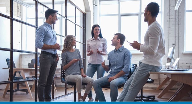 Employees in an office ask questions about digital transformation