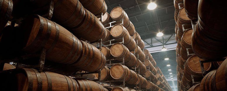Whiskey barrels stacked in a distillery