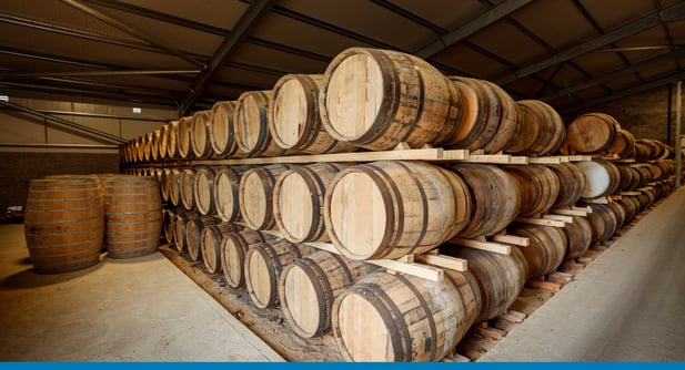 Distillery barrels in a warehouse that's using cloud ERP instead of Whiskey Systems